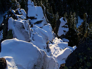 Snow covered rocks below summit.