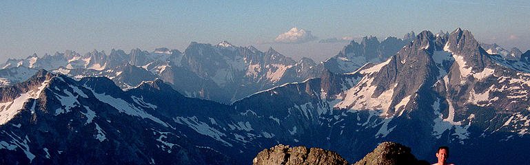 Pickets Traverse, viewed from Berdeen  the traverse enters via Challenger on the left, traverses in along the front side of the lefthand peaks, crosses Picket Pass in the center, and traverses out along the back side of the righthand peaks.  (Foreground is Mystery Ridge & Despair.) (labeled)