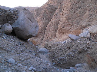 Big rock about to fall into wash