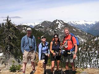 4/5's of the two-legged motley crew on the summit - with Sadie supervising.  Glacier Peak is the snow-covered peak above Bob's (in orange) head.  First summit of Dirty Face can be seen in front of Glacier.