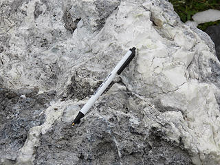The blocks tend to be weak and often decompose into piles of fragments. The blocks formed in  Sherman Crater due to chemical weathering and  most likely got here by being blasted out of the crater by steam-generated explosions (phreatic eruptions) onto the surface of the Easton Glacier, whose movement brought them downslope. Melting exposed the shermanite.  Smaller fragments are visible in trailside exposures at Schreibers Meadow carried there by a lahar (Schreibers Meadow lahar).