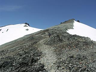climbers trail between E and Middle summits with W summit background left.