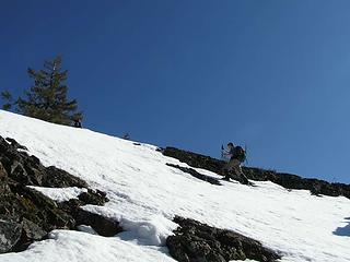 Jim K heading up the ridge against a cloudless sky