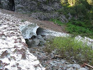 Approaching Snow Cave IV. Covered in avalanche debris and invisible from the rest of the snowfield, this last of the caves to open up is not very impressive.