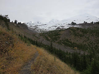 The trail gradually descends on the inner side of the  right lateral moraine of the Easton Glacier to the upper crossing of Rocky Creek. If you think this should be the LEFT lateral moraine,  lateral moraines are designated based on a down-glacier view. This view is looking up-glacier.