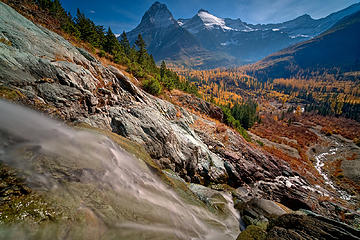 Long Knife Creek descends to join Kintla Creek on a fall day in the North Fork of Glacier National Park while the larches look on.