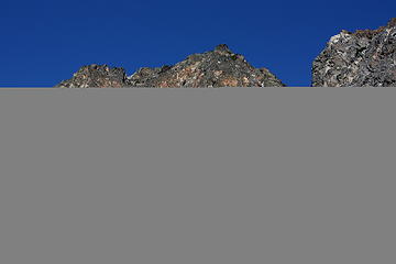 Just off the climber's trail. The route follows the boulders until the top right of the snow field, then follows ledges to the right,  and turning back to the left near the notch.