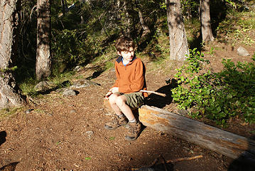 Gabe whittling in the morning sunshine