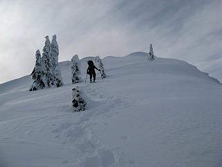 Yana ascending the final wind-packed slope