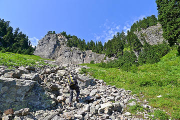 After a steep huckleberry-assisted descent on the east side of the ridge (no pictures), this talus finger leads up to the base of a gully that provides access to the summit ridge