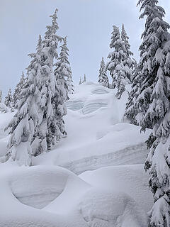 Tiers of icy ledges have built up on rocky areas above