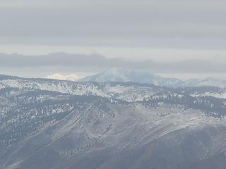 Stormy, Hardy, and Forest Mountains and far to the left in white mountains in the Sawtooth area across Lake Chelan.