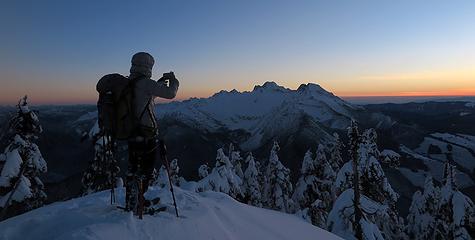 Carla taking a photo toward the Sisters Range