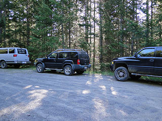 Three vehicles at end of road.