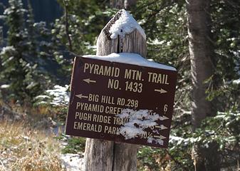 a bit of snow on the trail sign