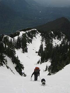 Climbing the final snow slopes to the notch. The NW ridge and Skykomish valley behind.