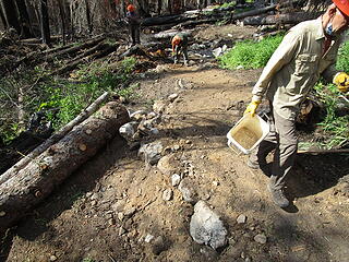 Tom hauling what seemed like hundreds of buckets of sand, gravel, and rocks