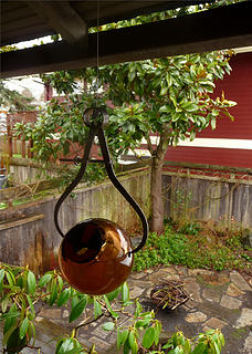 Colleen's late father's calipers and a candle holder hopefully rings the dinner bell for the smallest bird.  They love the rose of sharon 20 feet to the north, so chances are good they'll stop in.