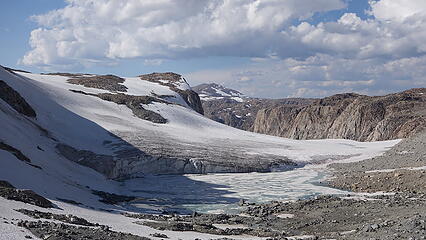 Ice cliff above milky lake below Grasshopper Glacier