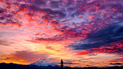 Sunrise over Bonney Lake, Washington with Mount Rainier casting a shadow against the clouds.
