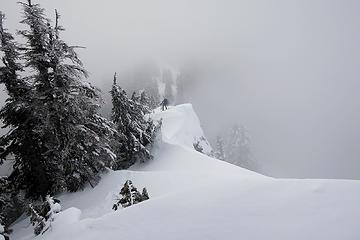 Carla following along the ridge (she standing on a spot of bare rock, not cornice snow)