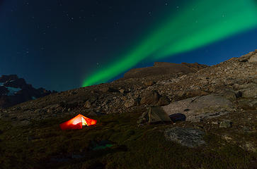 Despite full-moon brightness that limited the number of visible stars, the Aurora Borealis blazed through the sky above our mountain campsite high above Torssukatak Sound in southern Greenland.