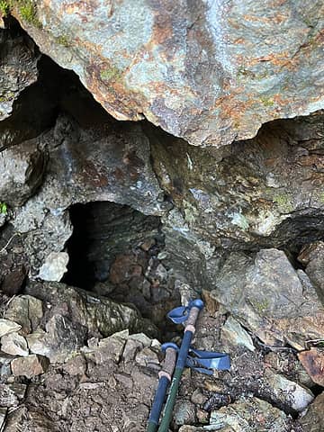 Poles for scale on how small the entrance to the cave is