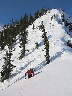 Wading through sun-softened snow near Sourdough Lake Col