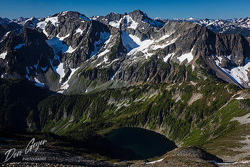 Doubtfull Lake nestled into a basin below Sahale Arm and peaks of the North Cascades, North Cascades National Park, Cascade Range, Washington, USA.
