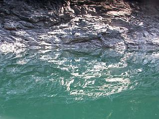 is it an underwater extension of the rock, or just a reflection?