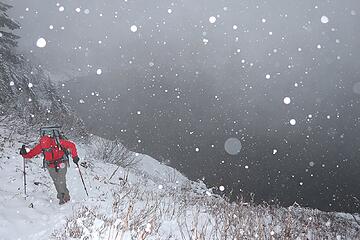 Carla hiking above snowy Lake Lillian