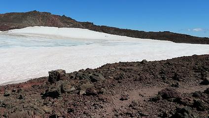 Hikers on the caldera snow, just below the true summit...