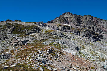 Follow the spine in this picture to small cliffy area just below the sky. Go left and around the cliffy area.  Then, back to the right toward the high point on the saddle.