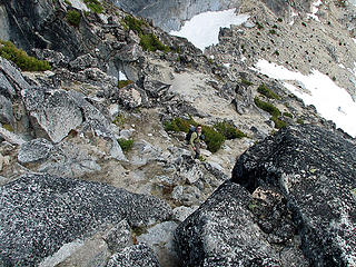 wildernessed downclimbing the rock with Colchuck col in the background.