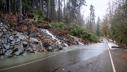 The rocky bank had a few rocks fall on 10/21, but now the entire bank slumped down onto the road.