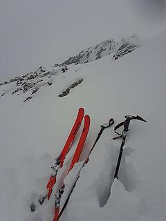 Ditching the skis, looking up at the summit