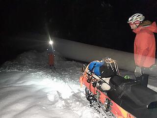 Three people with one snowmobile