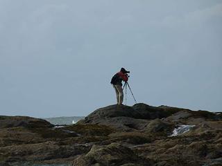Lone photographer out on distant rocks