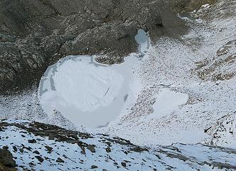 Frozen tarn below remanant of east Lyall Glacier