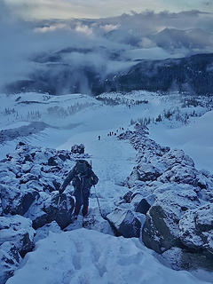 Crossing some boulders with a slew of climbers behind