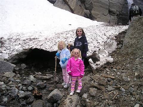 Standing at the mouth of a small ice cave.