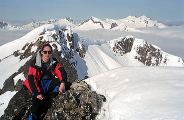 Matt on summit, with north end of Buckindy Traverse behind