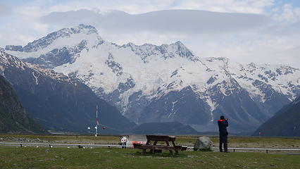 A tourist enjoys the view of Mount Sefton from the airport