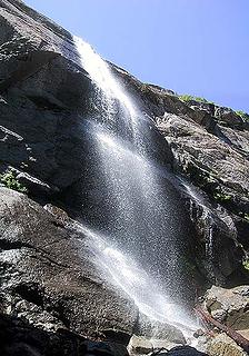 Vertical pan of the snow bridge falls from the moat between cliff and ice.