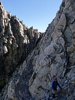 Scrambling to the north couloir down the sloping ledge