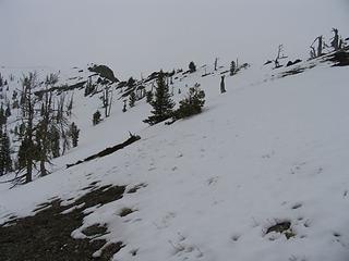 Looking up toward the upper ridge and the first of two false summits (cliffy outcrop). Photo at about 6140 ft.