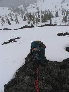 Scrambling over one of the rock outcrops (6300 ft) below the false summit