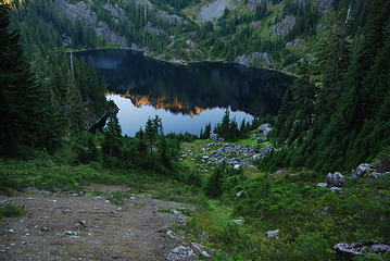 View from the east ridge above Lake Lillian with the alpenglow reflection in the water.